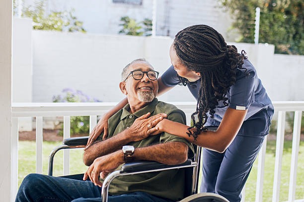 imageye imgi 10 young female nurse hugging an elderly man in a wheelchair.jpg