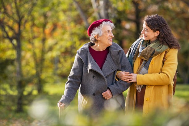 Imageye Imgi 62 Senior Woman Walking With Granddaughter In Park During Autumn